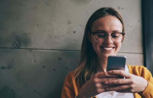 Cheerful,hipster,girl,in,eyeglasses,feeling,excited,of,chatting,with